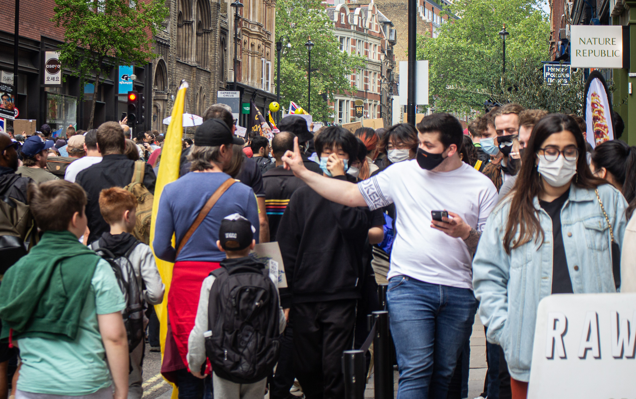 A masked man opposing anti-lockdown protestors